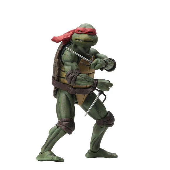 A Teenage Mutant Ninja Turtles action figure with a green and gray body, holding a sword and a staff, wearing a bandana and a belt.