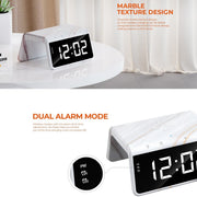 Digital clock with marble texture design on a white surface.