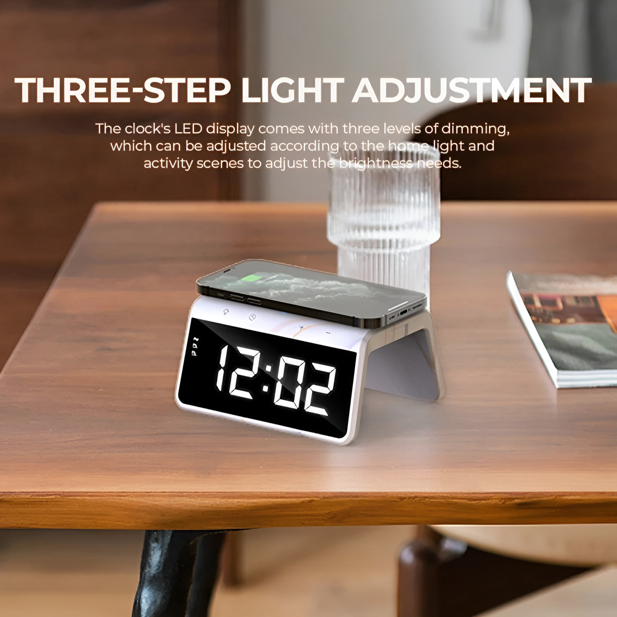 Digital clock with wireless charging pad on a wooden table, featuring three-step light adjustment text.