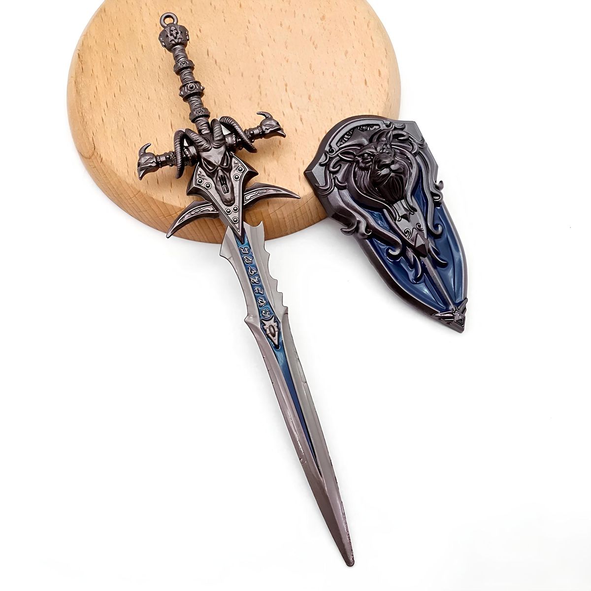 World Of Warcraft Frostmourne Sword And Anduin Shield Metal Keychain, Decorative sword and sheath on a wooden block with a white background
