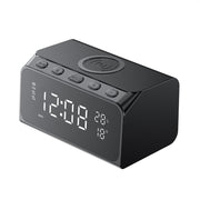 Black digital clock with wireless charging pad on a white background