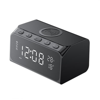 Black digital clock with wireless charging pad on a white background
