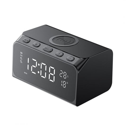 Black digital clock with wireless charging pad on a white background