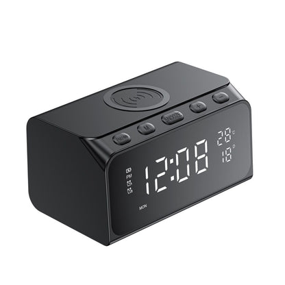 Black digital clock with wireless charging pad on a white background