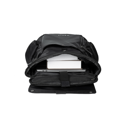 Black backpack with a laptop and books inside on a white background
