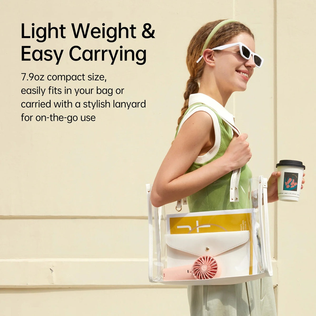 Jisulife Life4 Handheld Fan 3600mAh 5 Speed LED Display Woman holding a transparent bag with a design, wearing sunglasses and a green dress, against a beige wall.
