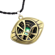Gold pendant with green gemstone on a black cord against a white background / Marvels Doctor Strange - Eye of Agamotto Necklace