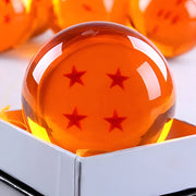 Orange crystal ball with four red stars in a box