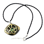 Gold and black pendant necklace with a green gemstone on a white background / Marvels Doctor Strange - Eye of Agamotto Necklace