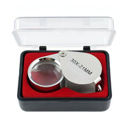 Silver magnifying glass with red interior in a clear box on a white background / Magnifying Jewelers Eye Loupe - 30x Magnification