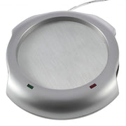 USB Mug Warmer And 4 Port Hub, Round metallic object with a white background