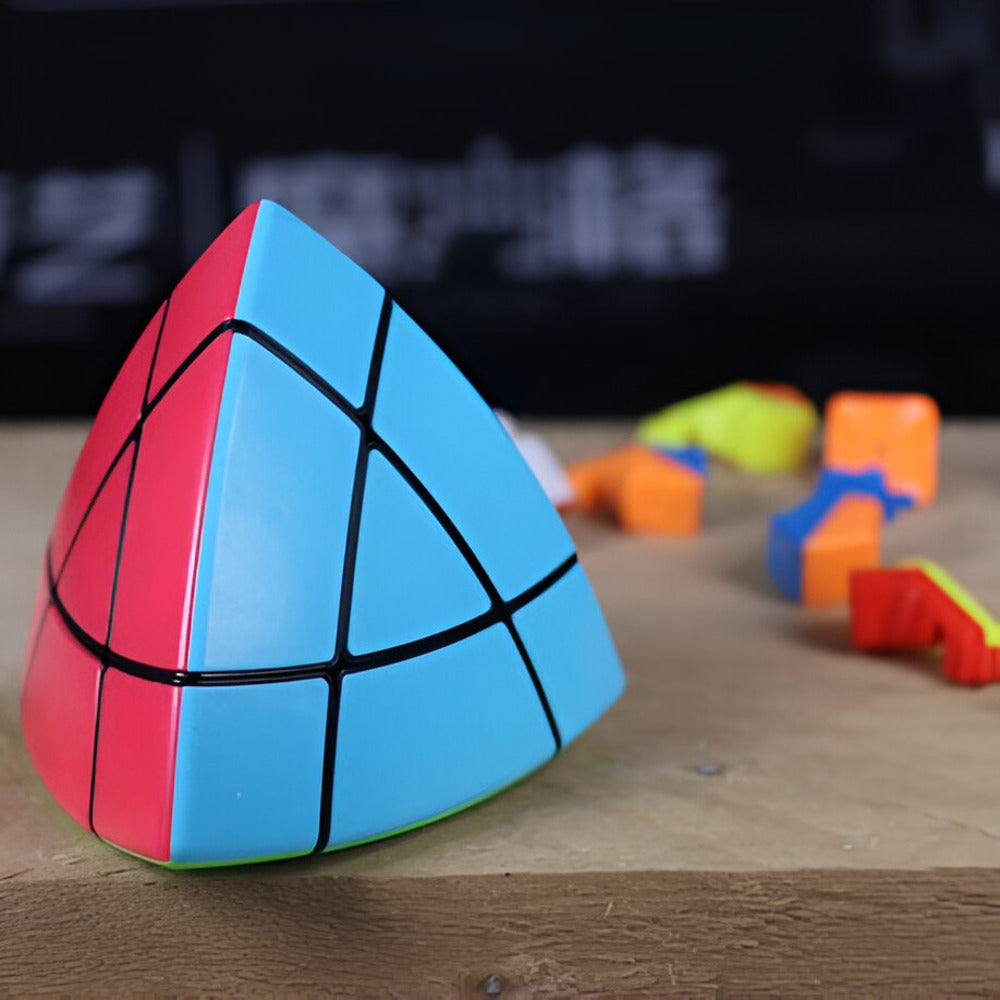 Pyraminx puzzle on a wooden surface with blurred background