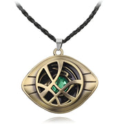 Gold pendant with green gemstone on a black cord against a white background / Marvels Doctor Strange - Eye of Agamotto Necklace