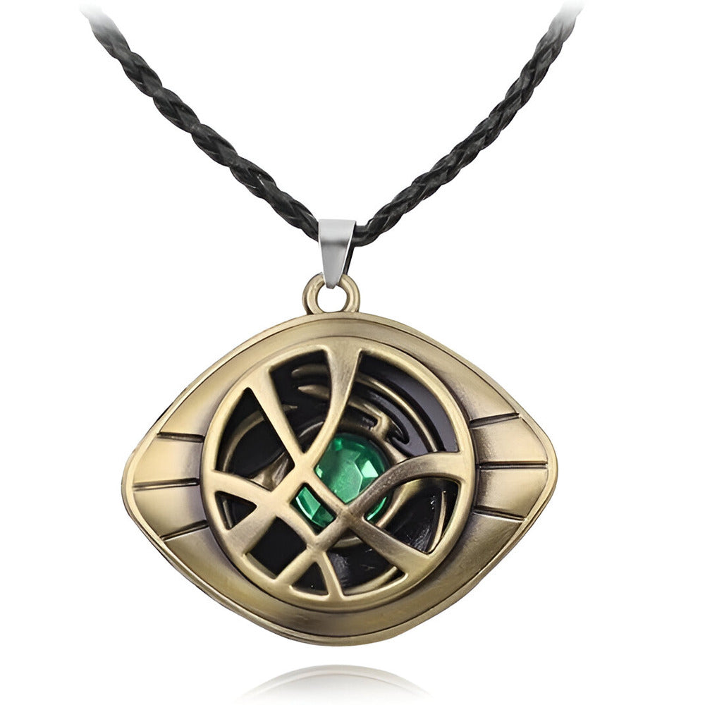 Gold pendant with green gemstone on a black cord against a white background / Marvels Doctor Strange - Eye of Agamotto Necklace