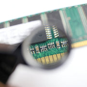 Close-up of a computer memory module under a magnifying glass / Magnifying Jewelers Eye Loupe - 30x Magnification