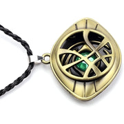 Gold pendant with green gemstone on a white background / Marvels Doctor Strange - Eye of Agamotto Necklace