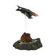 Decorative item with a bird perched on a rocky outcrop on a white background